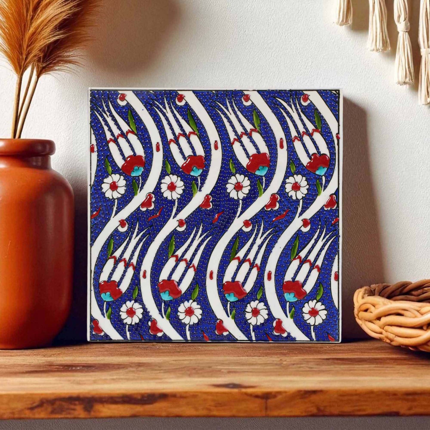 Decorative ceramic tile with floral pattern on a wooden surface