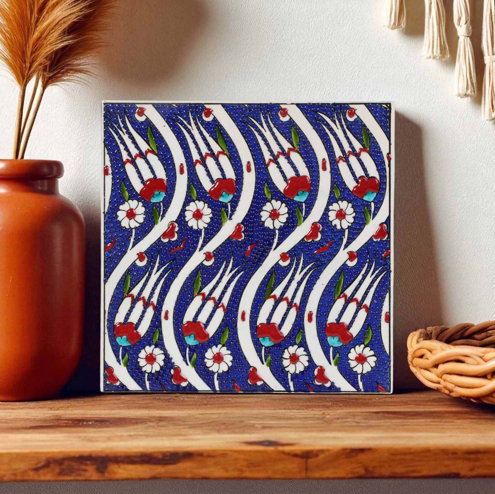 Decorative ceramic tile with floral pattern on a wooden surface