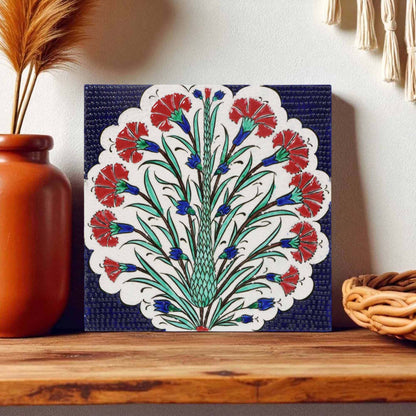 Decorative ceramic tile with floral pattern on a wooden shelf