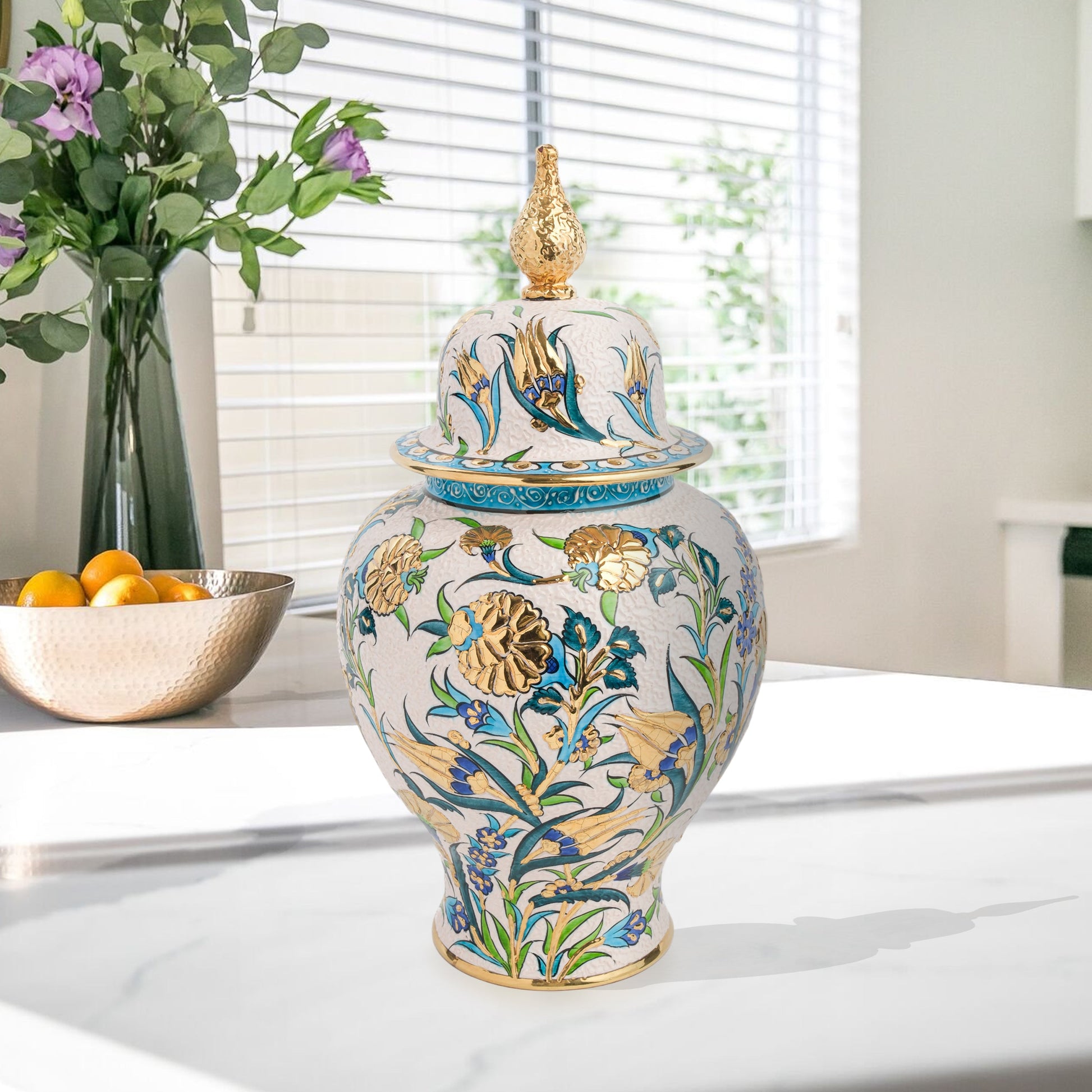 Hand-painted Golden Bloom ceramic jar with blue tulips, green leaves & gold accents. Finished with sculpted golden finial, artisan-made, perfect décor or gift.