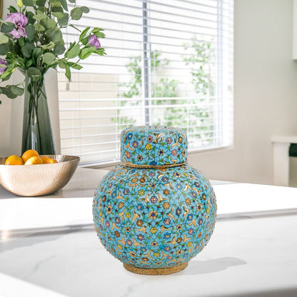 Hand-painted Turquoise Blossom ceramic jar with lid. Features floral motifs in turquoise, lavender & gold. Round melon shape, artisan-made, perfect décor.