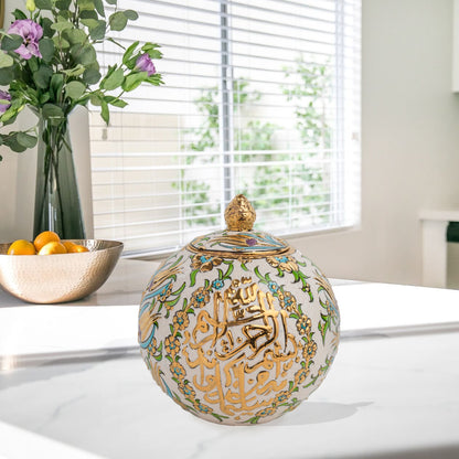 Hand-painted Floral Script globe jar with golden Arabic calligraphy and turquoise floral motifs. Spherical ceramic design, artisan-made, perfect décor or gift.
