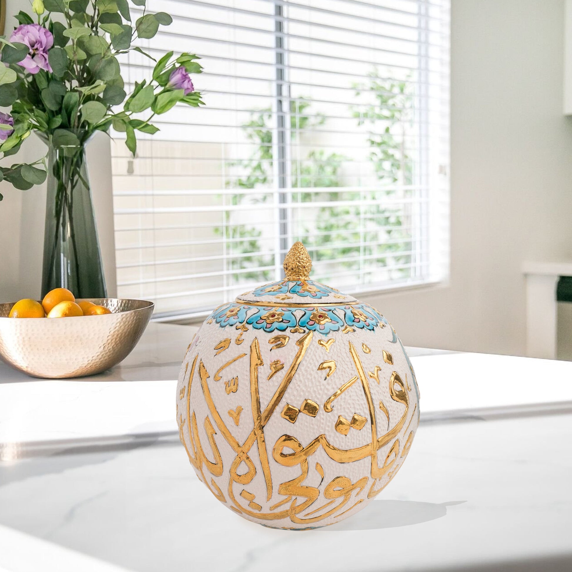 Hand-painted Gold Script globe jar with Arabic calligraphy in gold and turquoise floral trim. Spherical ceramic jar with gilded finial, perfect décor or gift.