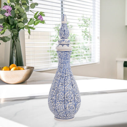 Hand-painted Iznik Nightingale’s Eye ceramic vase with lid, featuring blue vine motifs on white. Tall Ottoman-inspired design, perfect for décor or gifting.