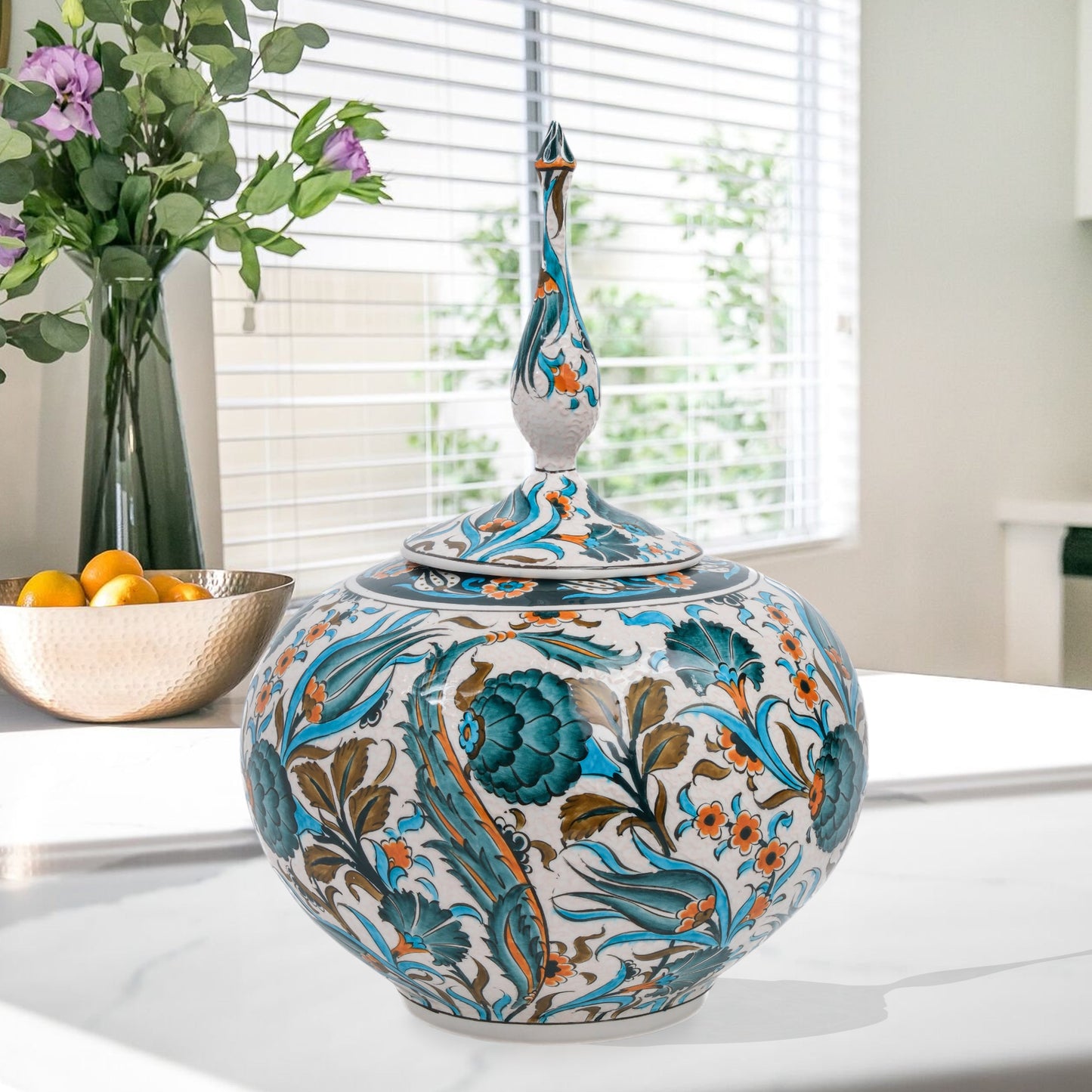 Hand-painted Iznik Bloom globe jar with teal blooms, tulips & vines on white. Bulbous Ottoman-inspired ceramic jar with finial lid, perfect décor or gift.