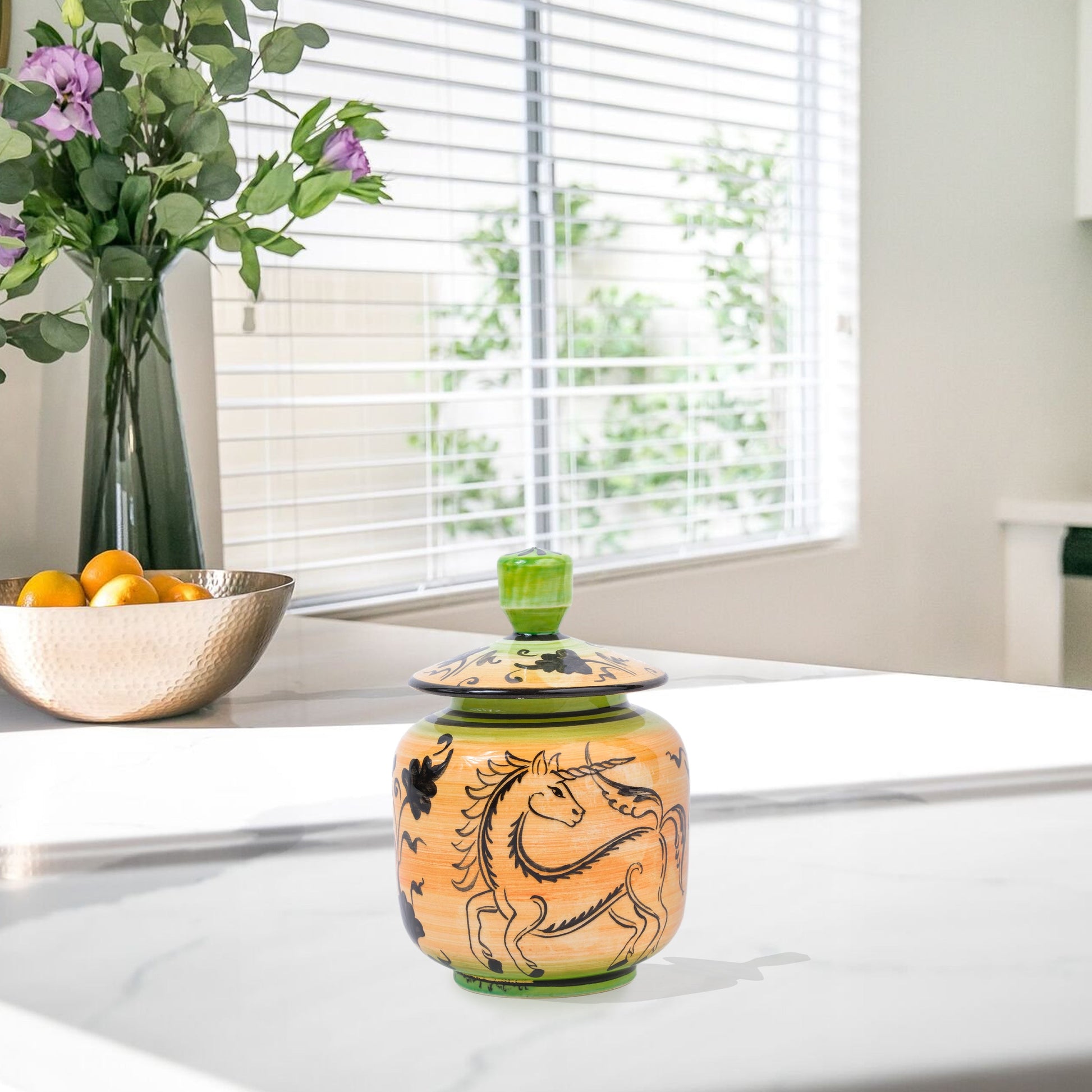 Hand-painted Unicorn Dance ceramic jar with whimsical black unicorn motif on orange & green. Lidded artisan jar, perfect for honey, ginger, spices, or décor.