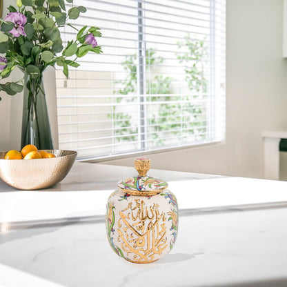 Hand-painted Divine Script ceramic jar with golden Arabic calligraphy and floral motifs. Lidded artisan jar, perfect for honey, ginger, spices, or spiritual décor.