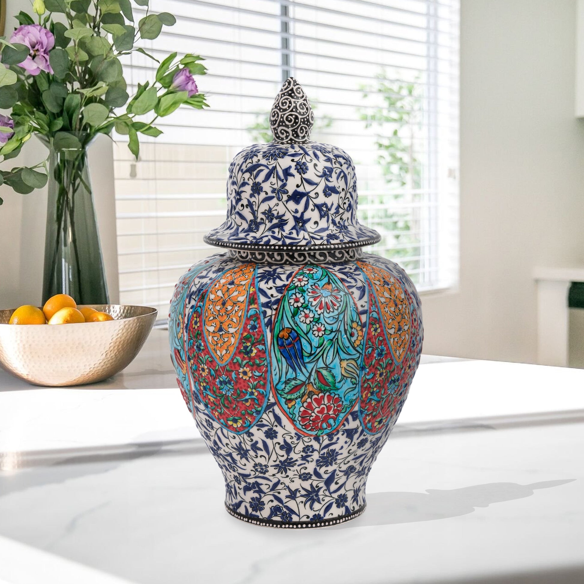 Hand-painted Garden Song ceramic jar with floral and bird motifs in vibrant panels. Lidded artisan jar with ornate finial, perfect décor accent or gift.