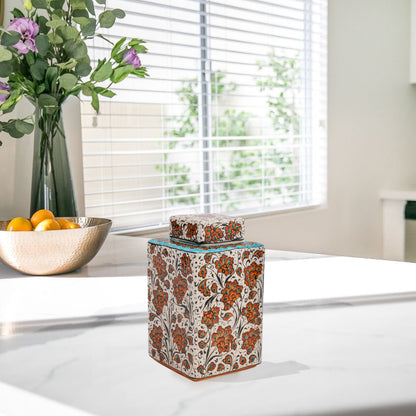 Hand-painted Terracotta Bloom ceramic jar with vivid orange floral motifs. Square lidded design, artisan-crafted, perfect for tea, spices, décor, or gifts.