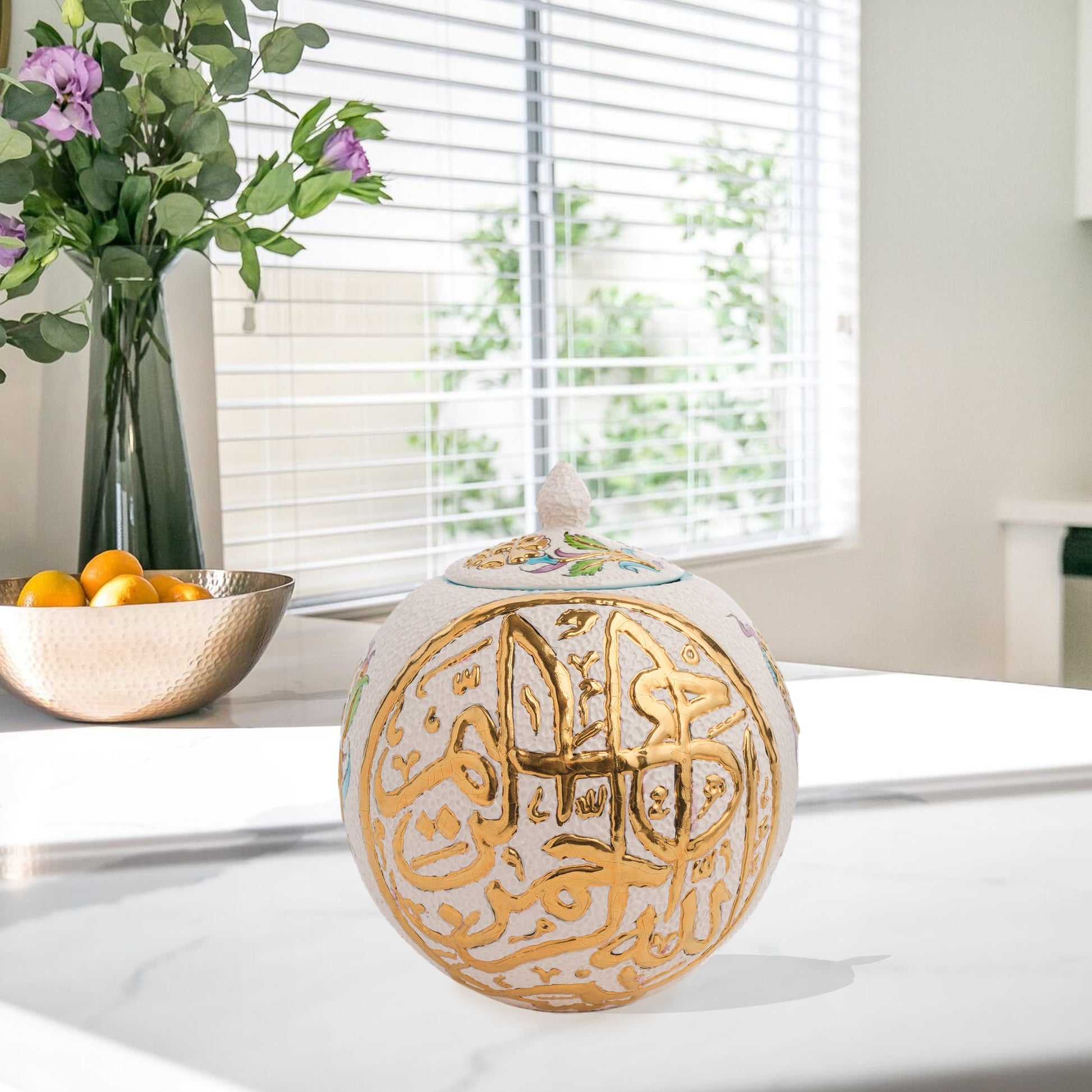 Hand-painted Gold Script globe jar with Arabic calligraphy and turquoise floral motifs. Spherical ceramic design with gold finial, perfect décor or gift.