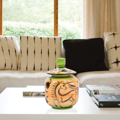Hand-painted Unicorn Dance ceramic jar with whimsical black unicorn motif on orange & green. Lidded artisan jar, perfect for honey, ginger, spices, or décor.