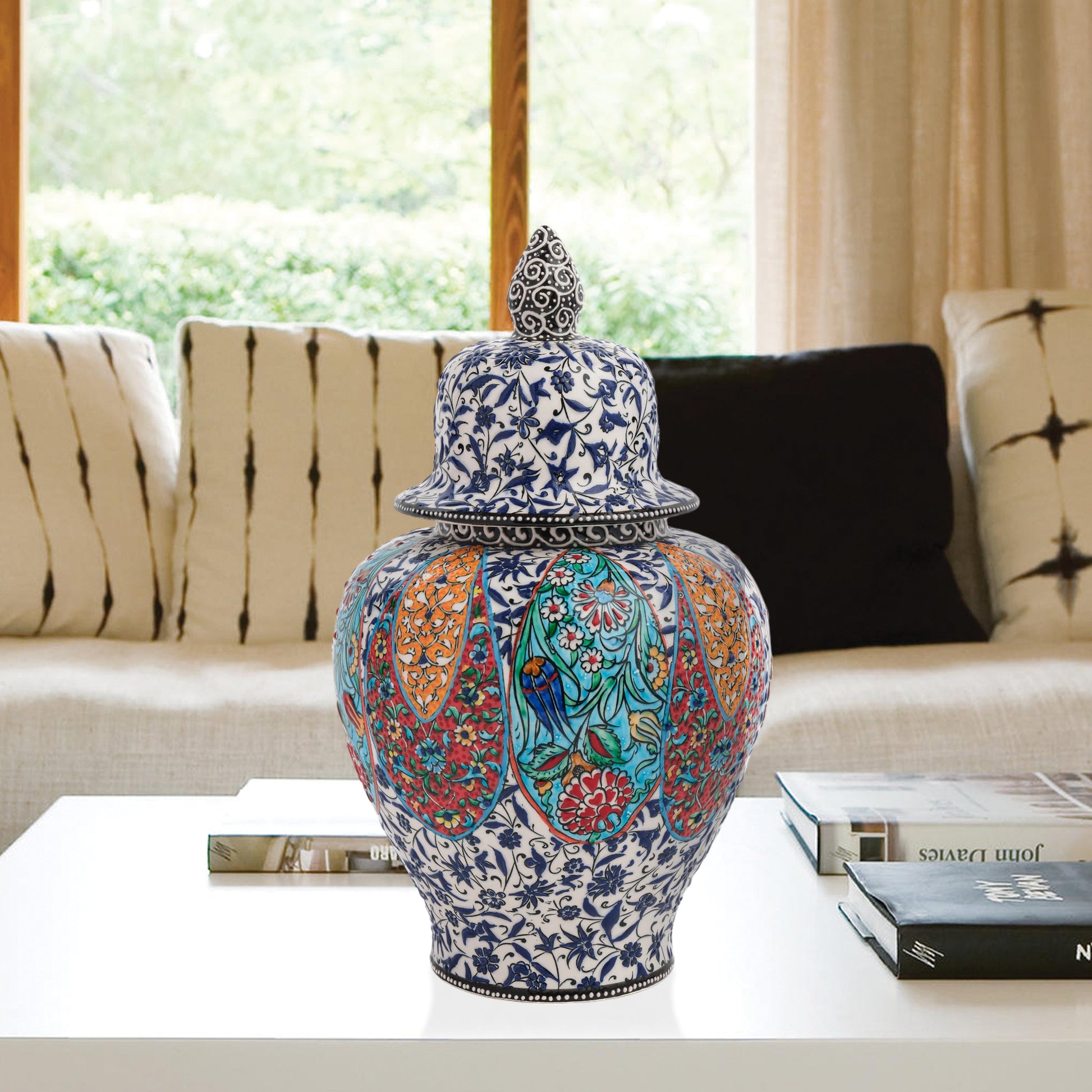 Hand-painted Garden Song ceramic jar with floral and bird motifs in vibrant panels. Lidded artisan jar with ornate finial, perfect décor accent or gift.