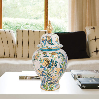 Hand-painted Golden Bloom ceramic jar with blue tulips, green leaves & gold accents. Finished with sculpted golden finial, artisan-made, perfect décor or gift.