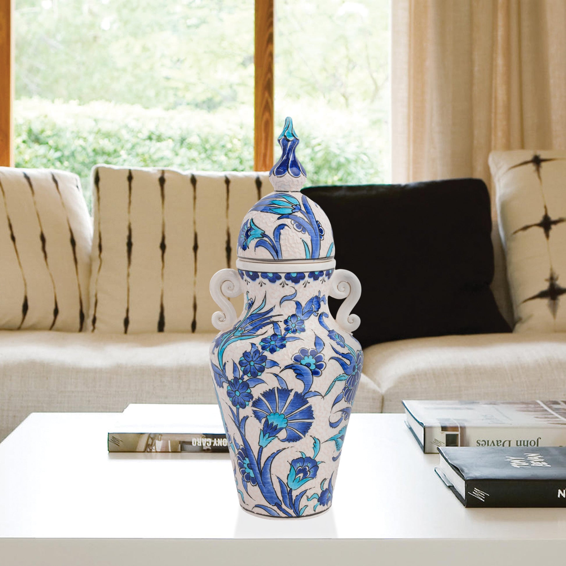 Hand-painted Azure Blossom ceramic jar with Turkish blue floral motifs and turquoise accents. Features handles and finial lid, perfect décor or collector’s gift.