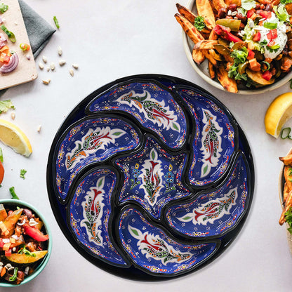 Decorative blue and black snack serving tray set with food on a white table