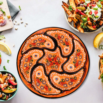 Decorative snack serving tray set with intricate designs on a table with food items.
