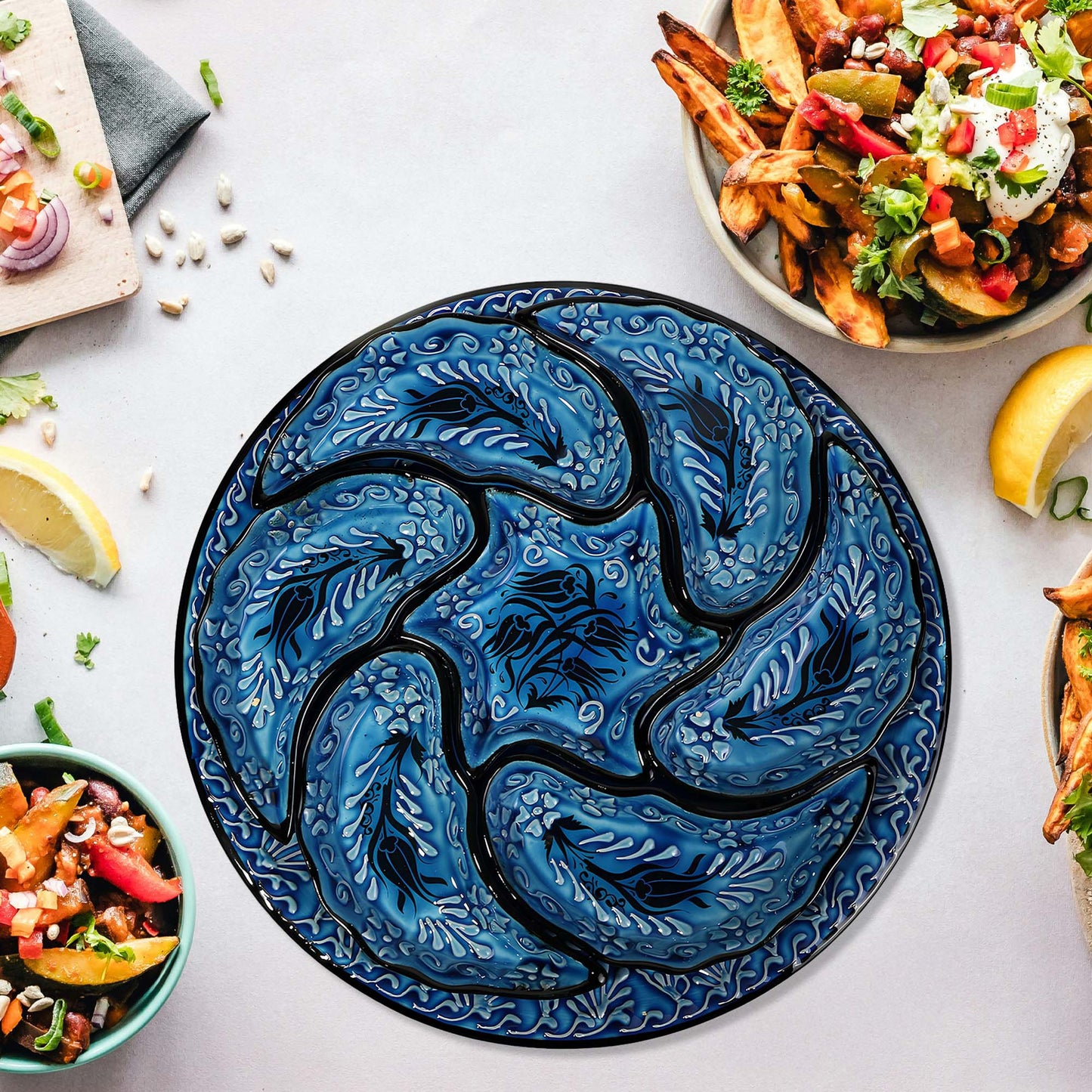 Blue tulip-patterned snack serving tray set on a table with food