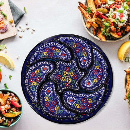 Decorative blue snack serving tray set with floral patterns on a table with food.