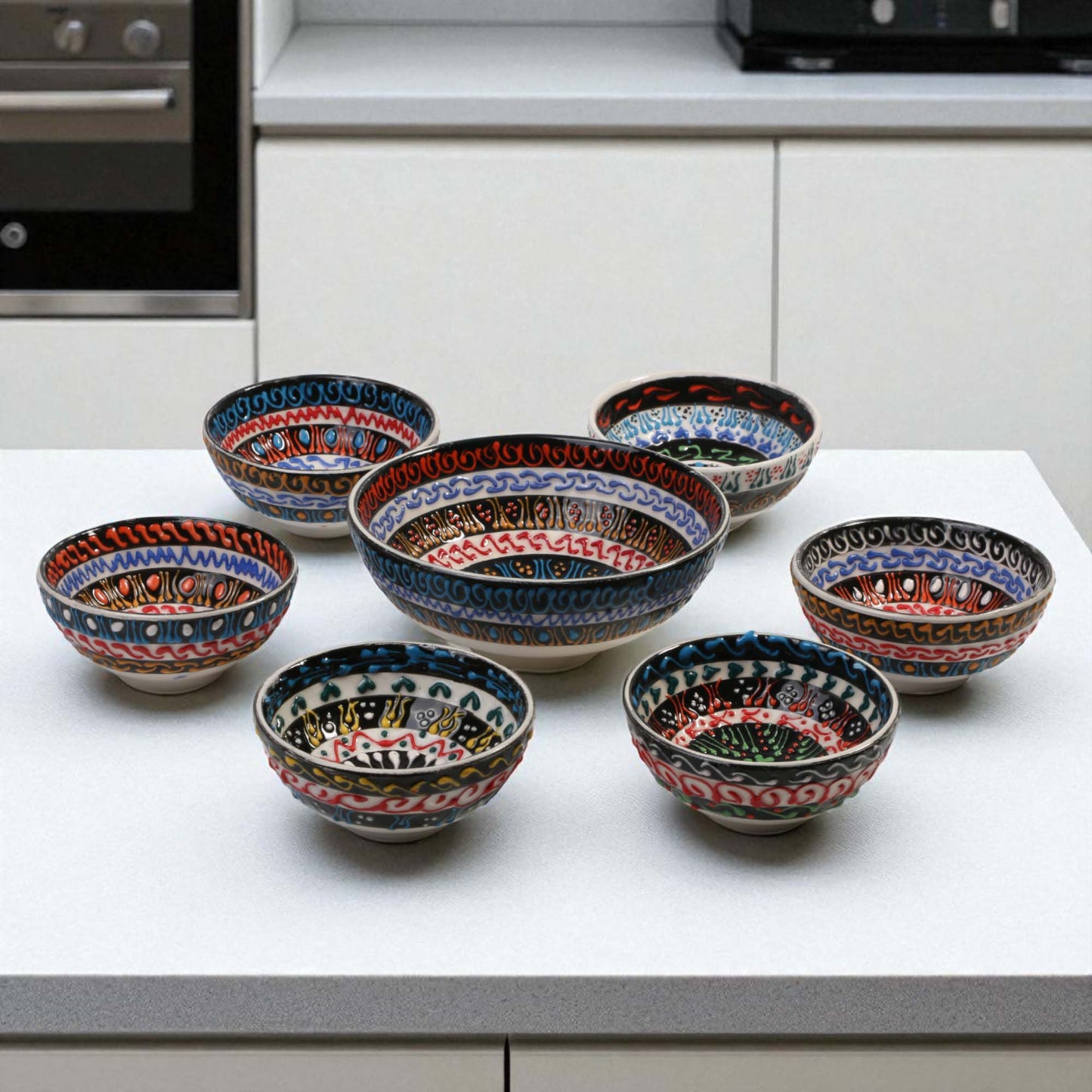Set of ceramic bowls with decorative patterns on a kitchen counter.