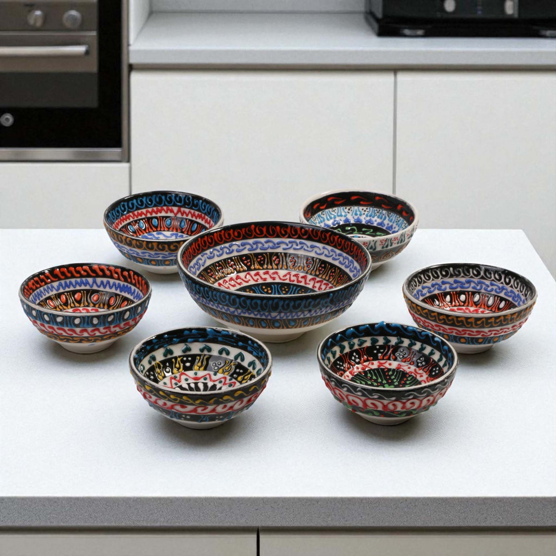 Set of ceramic bowls with decorative patterns on a kitchen counter.