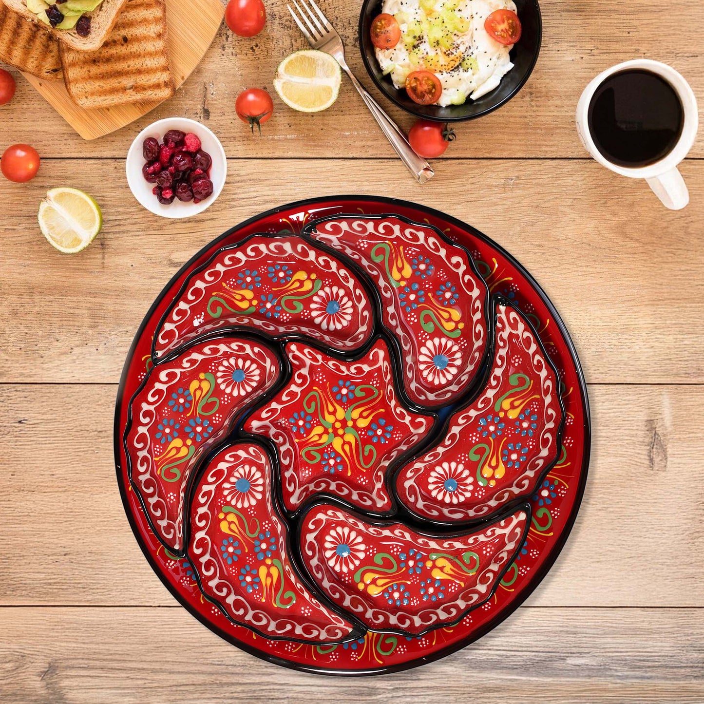 Decorative snack serving tray set with a colorful paisley design on a wooden table with food and coffee.