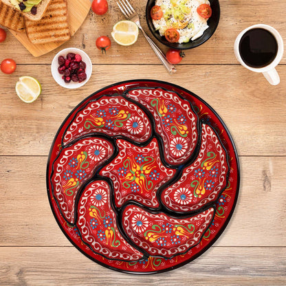 Decorative snack serving tray set with a colorful paisley design on a wooden table with food and coffee.