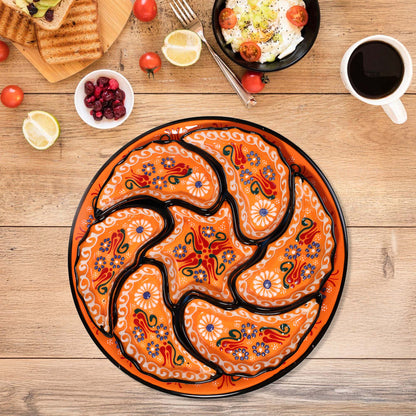 Decorative snack serving tray set with intricate patterns on a wooden table with food items.