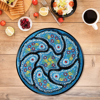 Decorative blue snack serving tray set with floral patterns on a wooden table with food items.