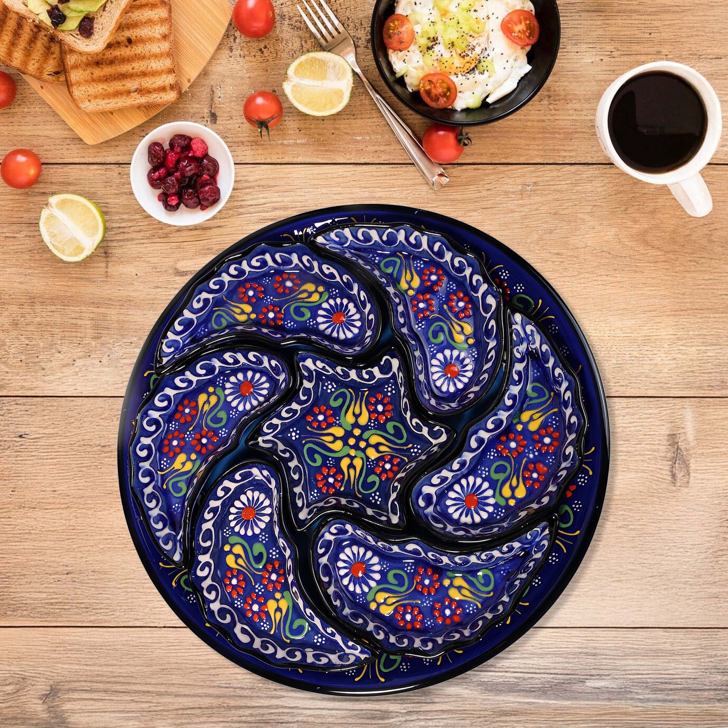 Decorative blue snack serving tray set  with floral patterns on a wooden table with food items.
