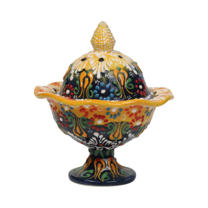 Decorative ceramic sugar bowl with a colorful floral pattern on a white background