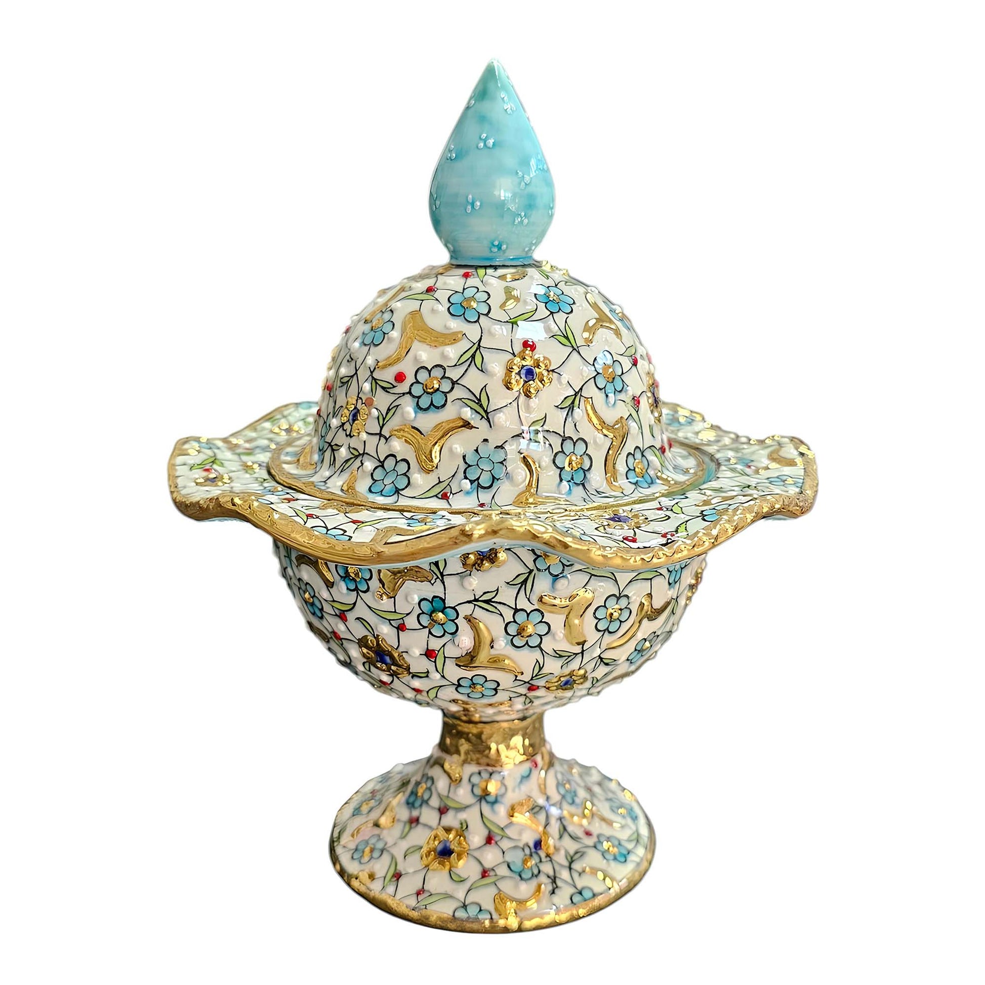 Decorative sugar bowl with floral patterns and a blue top on a white background