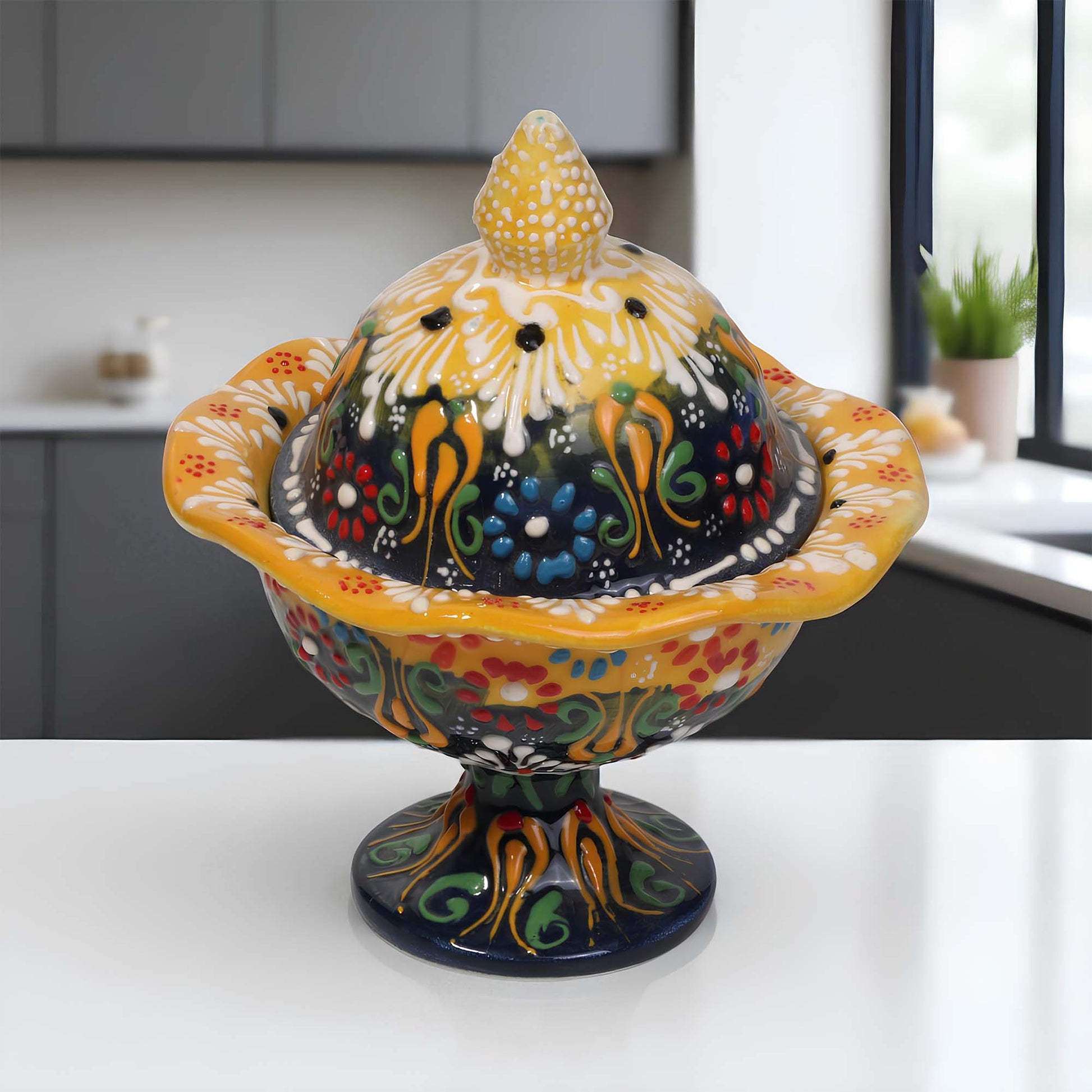 Decorative ceramic sugar bowl with colorful floral patterns on a white surface.