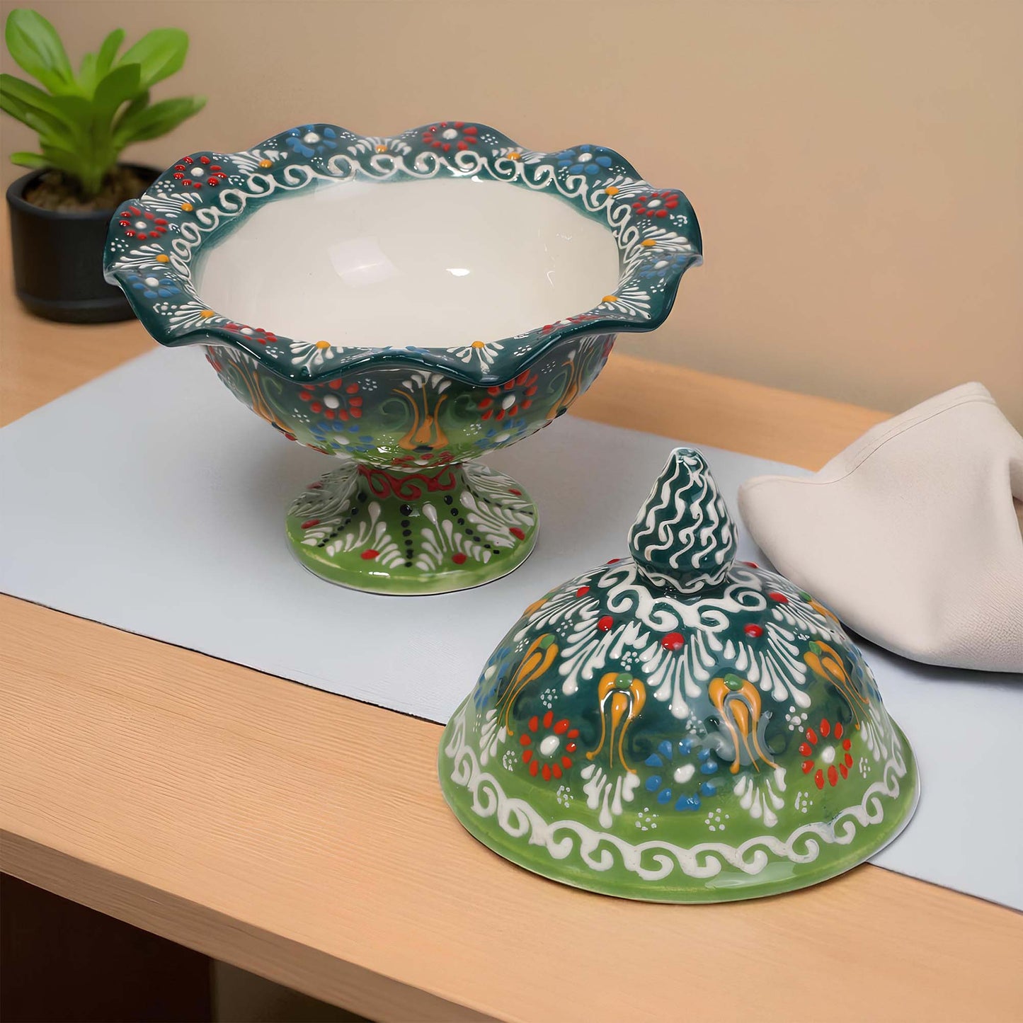 Decorative ceramic sugar bowl with a lid on a wooden surface