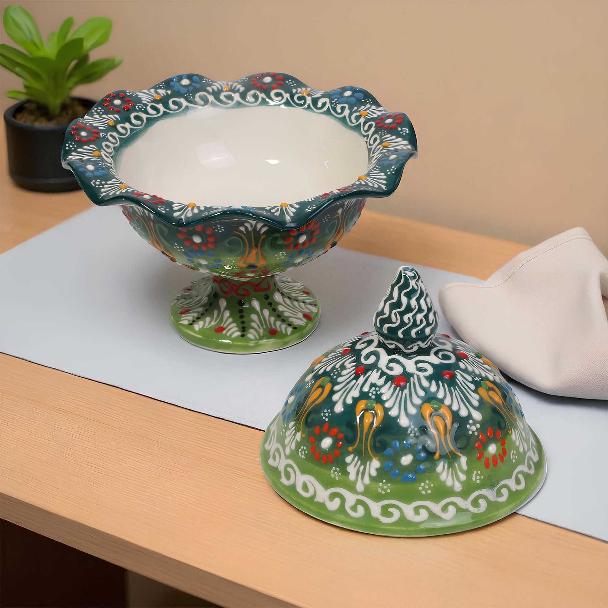 Decorative ceramic sugar bowl with a lid on a wooden surface
