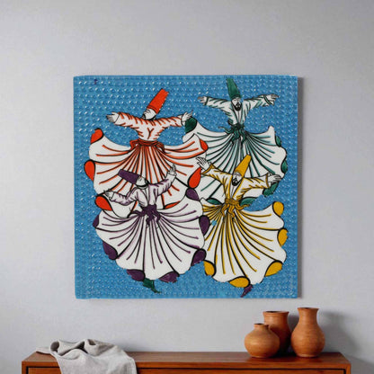 Colorful ceramic wall tile of dancers on a blue background hanging on a wall above a wooden cabinet with vases.
