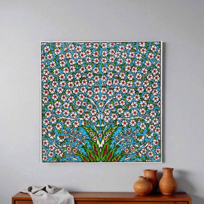 Decorative floral patterned ceramic tile wall art on a gray wall with wooden furniture and vases below.