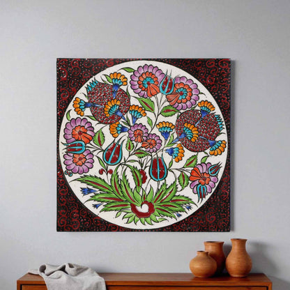 Decorative floral ceramic tile hanging on a wall above a wooden cabinet with vases.