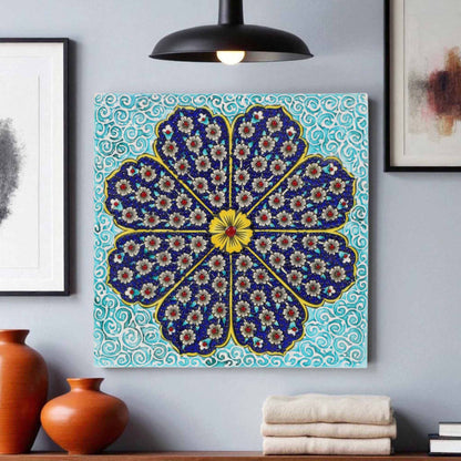 Decorative ceramic tile wall art with a floral pattern on a blue background, displayed in a room with vases and books.