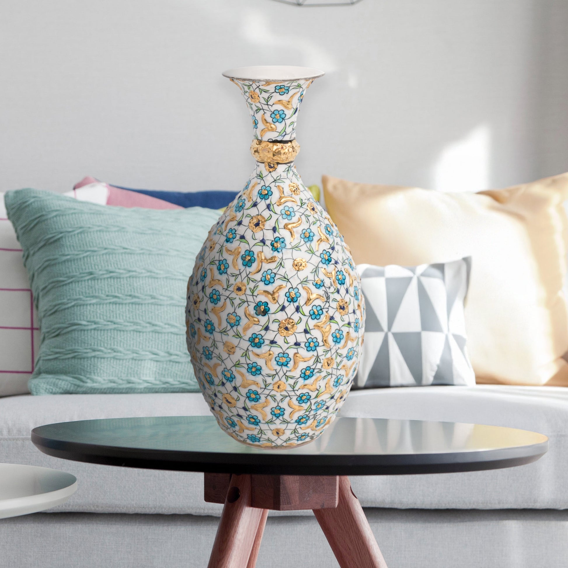 Hand-painted ceramic decorative bottle with turquoise and gold floral motifs on ivory. Glossy artisan vase, elegant décor accent, perfect for gifting.