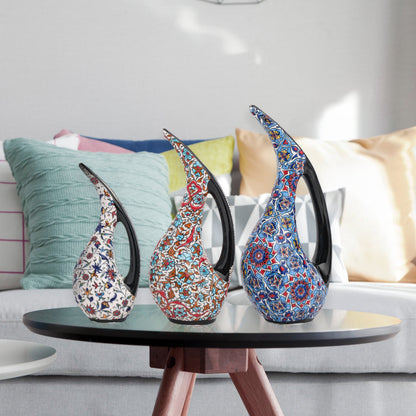 Set of 3 hand-painted ceramic ewers with Ottoman floral motifs in unique color palettes. Glossy artisan pieces with black handles, perfect décor or gifts.