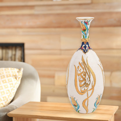 Hand-painted ceramic decorative bottle with golden Arabic calligraphy on ivory, accented with floral motifs. Glossy artisan vase, perfect for décor or gifts.