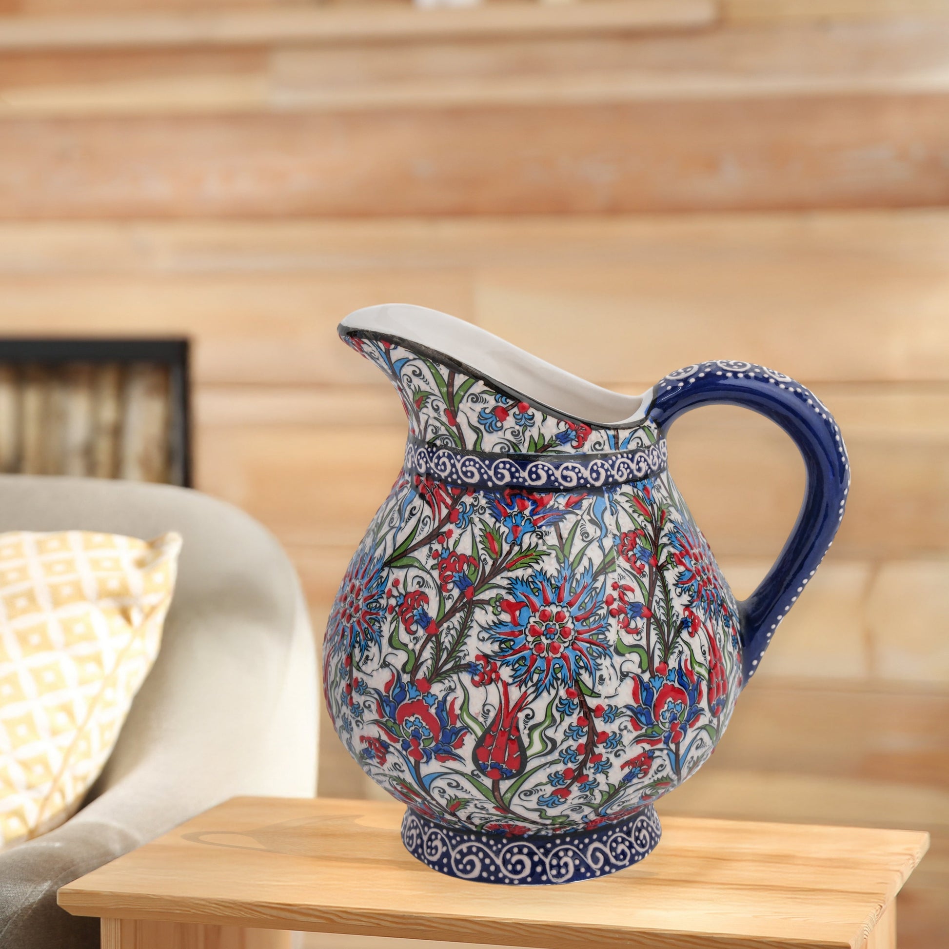 Hand-painted ceramic pitcher with Iznik-inspired tulips, carnations & leaves in red, blue & green. Decorative artisan piece, perfect for display.