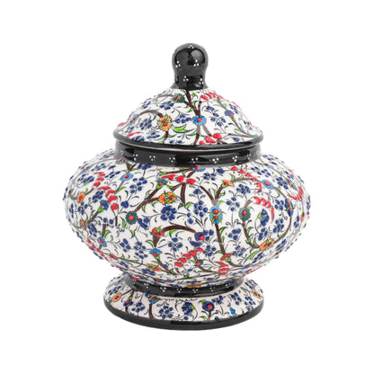 Handmade ceramic jar with a floral meadow design, featuring a lid, in a glossy finish.
