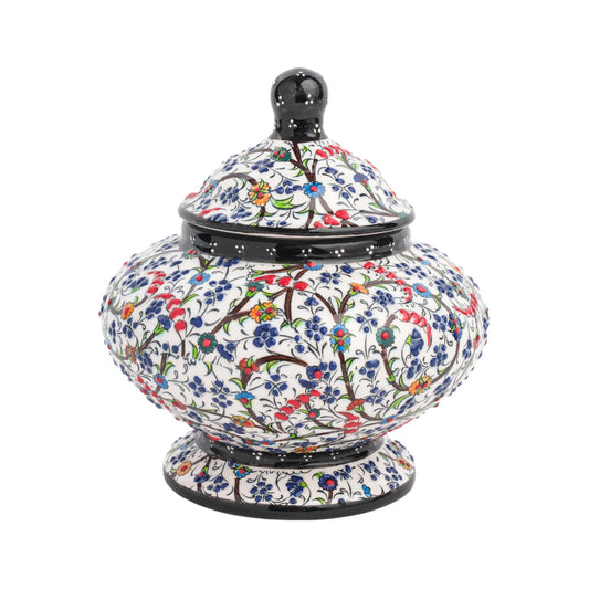 Handmade ceramic jar with a floral meadow design, featuring a lid, in a glossy finish.