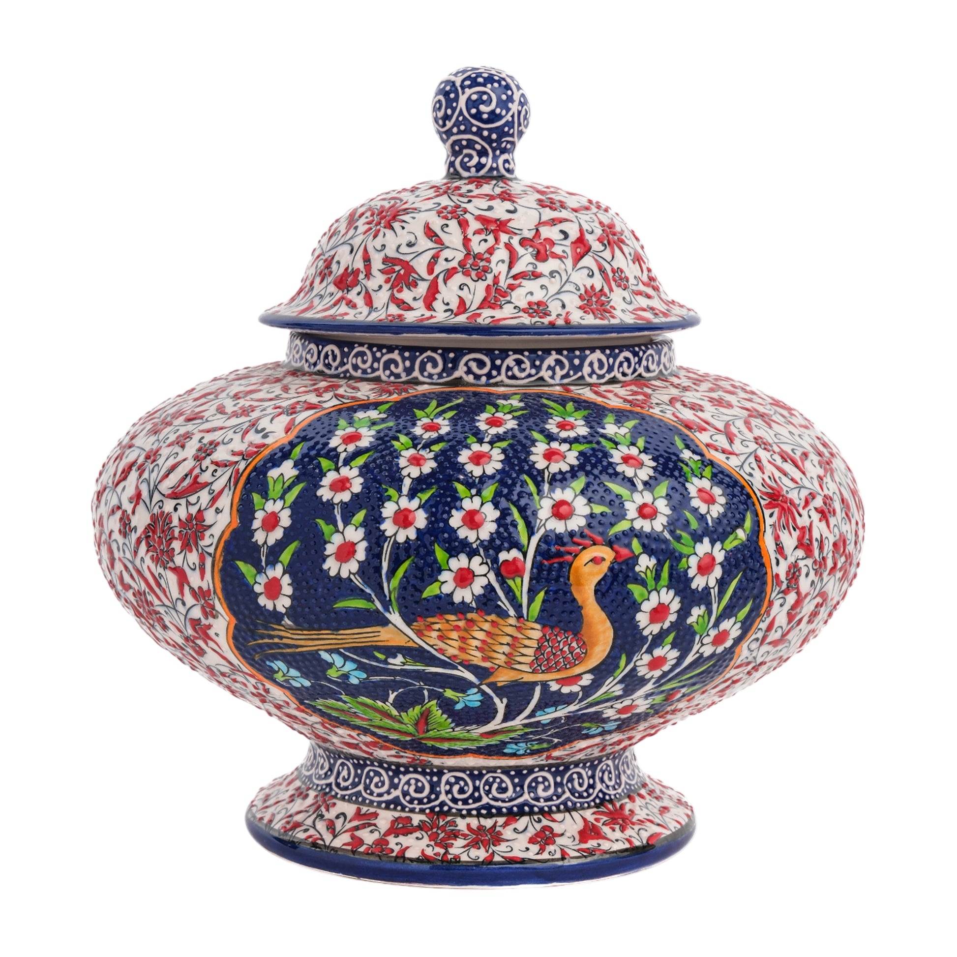 A hand-painted ceramic jar with a lid, featuring a bird amidst white flowers on a rich blue background, with additional floral motifs in vibrant colors.