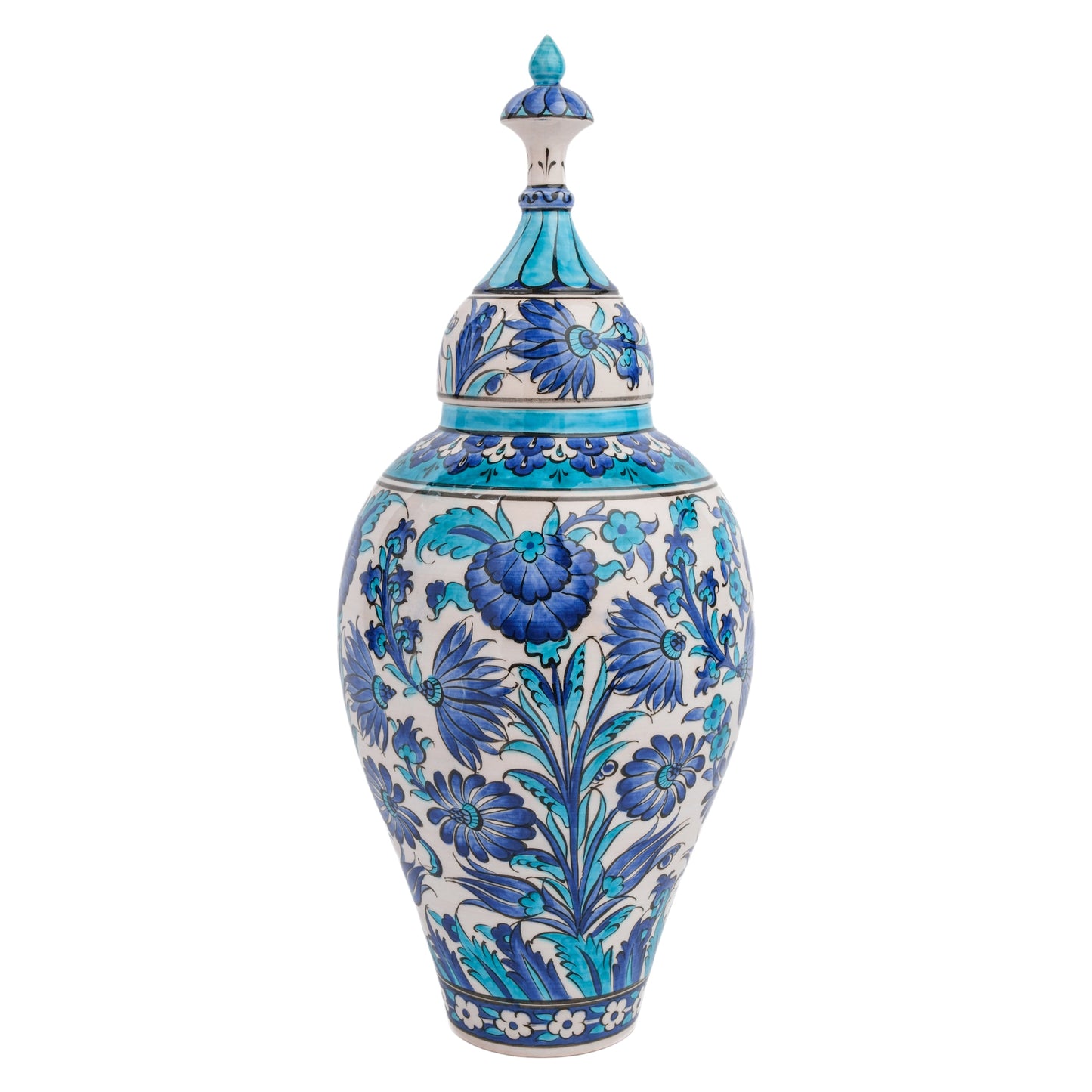 A tall, slender handmade ceramic jar with a lid, featuring intricate hand-painted floral motifs in blue and turquoise shades on a white background.