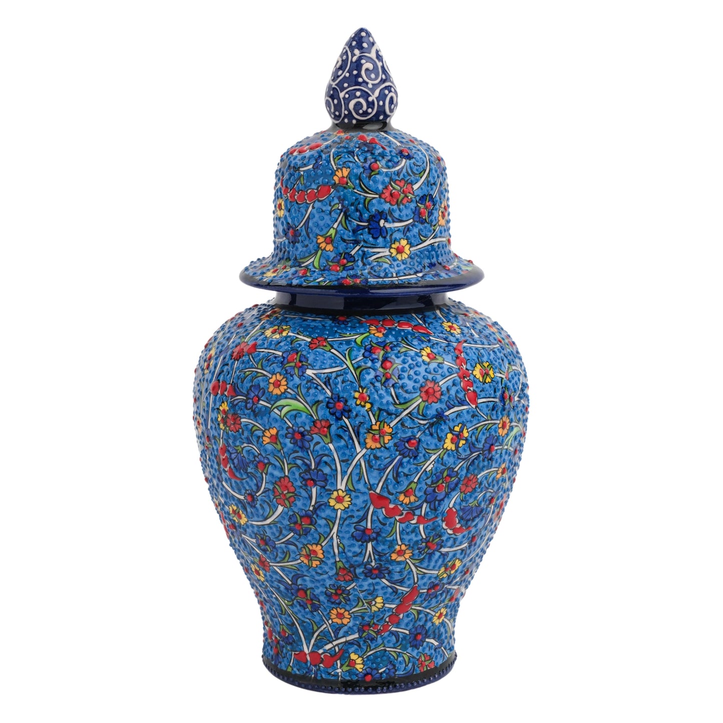 A hand-painted ceramic jar with a deep blue background and vibrant floral patterns in yellow, red, and blue, topped with a matching lid featuring a bird finial.