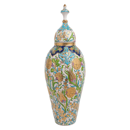 A tall, hand-painted ceramic vase with a gold detailed Ottoman-style floral design, including golden Ottoman-style carnations, tulips, and hyacinths on a white background, topped with a sculptural lid.