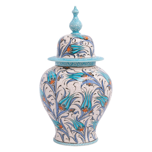 A hand-painted ceramic jar with a turquoise lid, featuring blue tulip motifs and orange details.