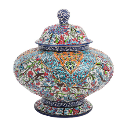 A hand-painted ceramic jar with a lid, featuring intricate floral and geometric motifs in vibrant tones of turquoise, orange, and navy.